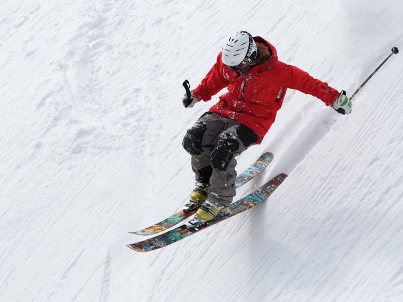 Teenagers enjoying ski lessons together during a youth winter sports camp in the mountains