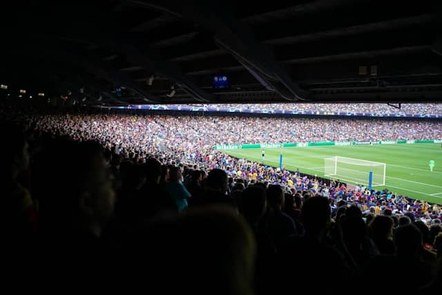 fans in a packed european stadium during a champions league night match