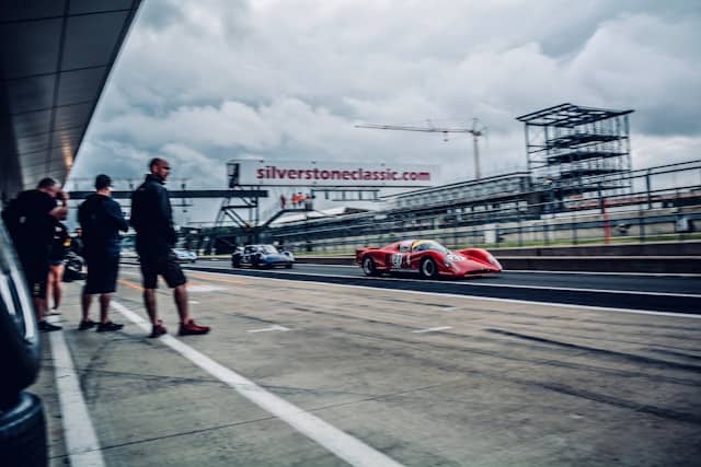 grandstands full of fans watching formula 1 cars race at silverstone circuit