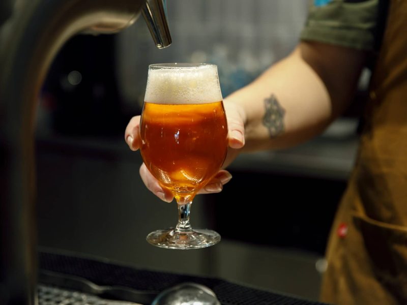 Friends enjoying a high beer and high wine with snacks in a cosy Dutch bar