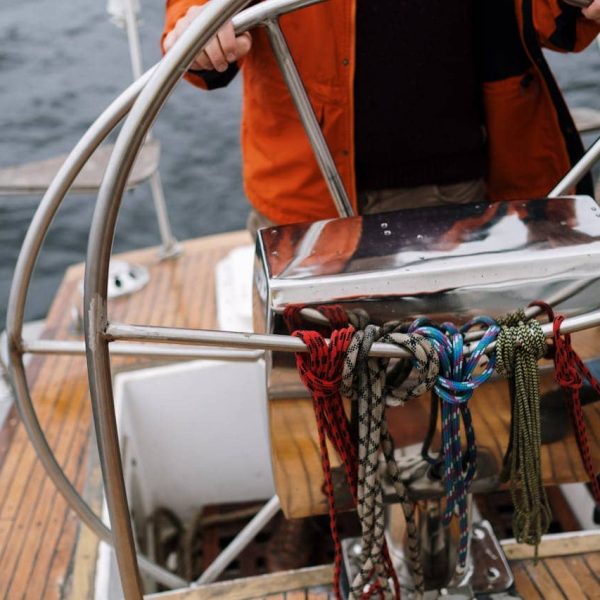 People enjoying a canal boat tour on the canals of Amsterdam on a sunny day