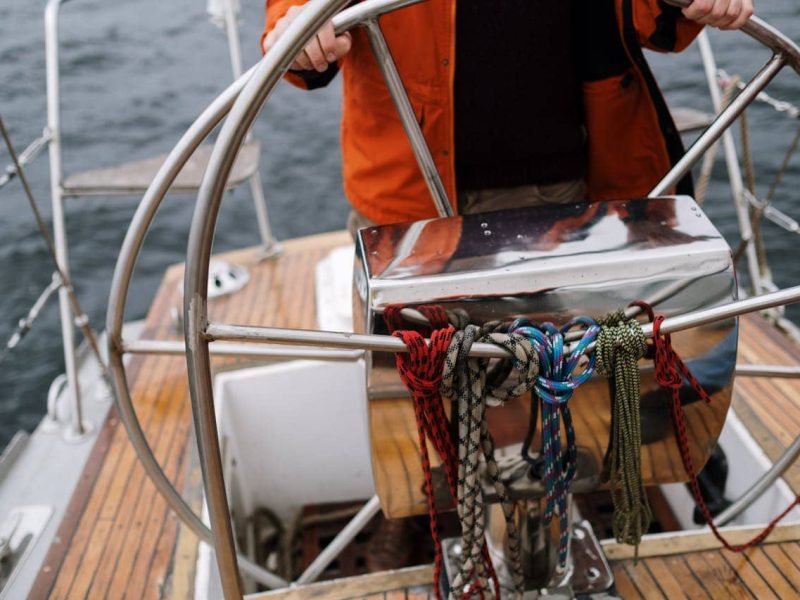 People enjoying a canal boat tour on the canals of Amsterdam on a sunny day